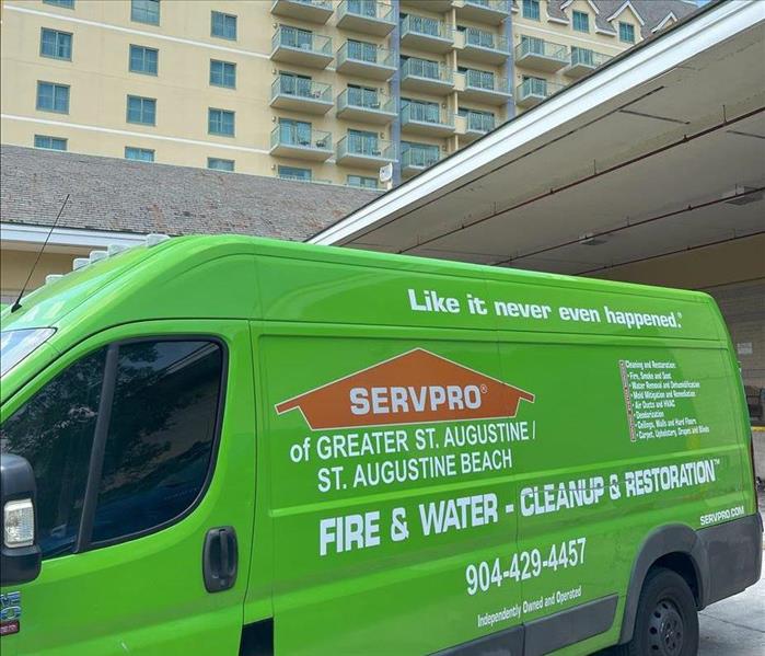 SERVPRO green vehicle outside the water damaged commercial building ready to start the restoration process 