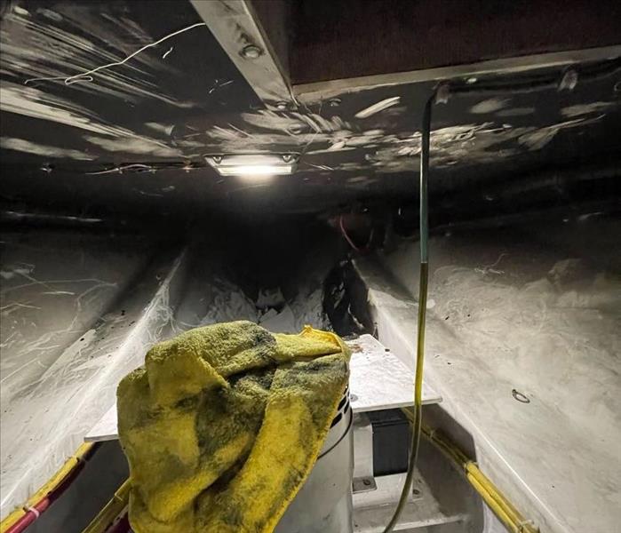 bilge of a yacht that suffered an electrical fire covered in soot and fire damage