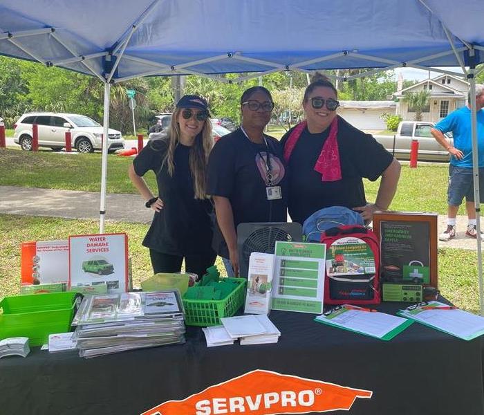 A picture of three volunteers at a community outreach event